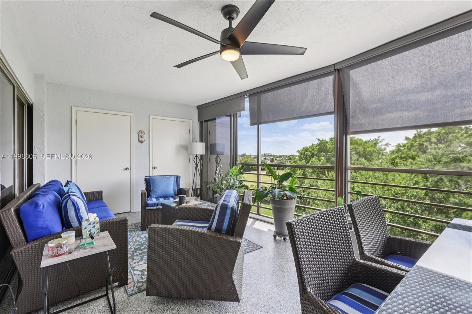 9170 Southwest 14th Street, Unit 4508 Boca Raton, FL 33428 - Photo 35 of 48 a living room with furniture and a floor to ceiling window