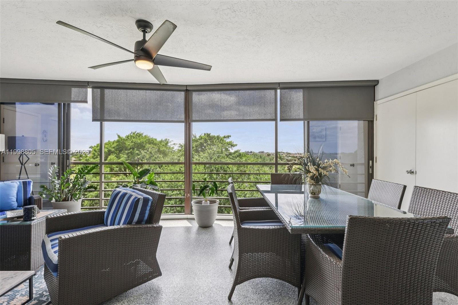 9170 Southwest 14th Street, Unit 4508 Boca Raton, FL 33428 - Photo 38 of 48 a living room with furniture ceiling fan and a large window