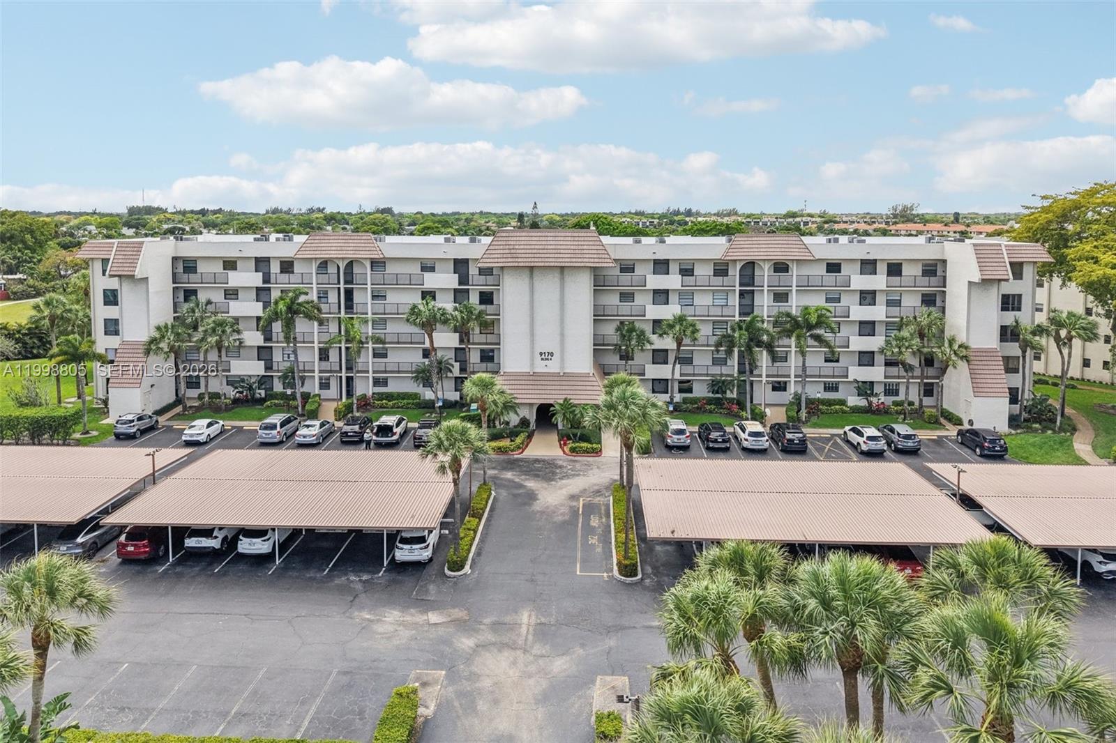 9170 Southwest 14th Street, Unit 4508 Boca Raton, FL 33428 - Photo 39 of 48 a view of a patio and table in back yard of the house