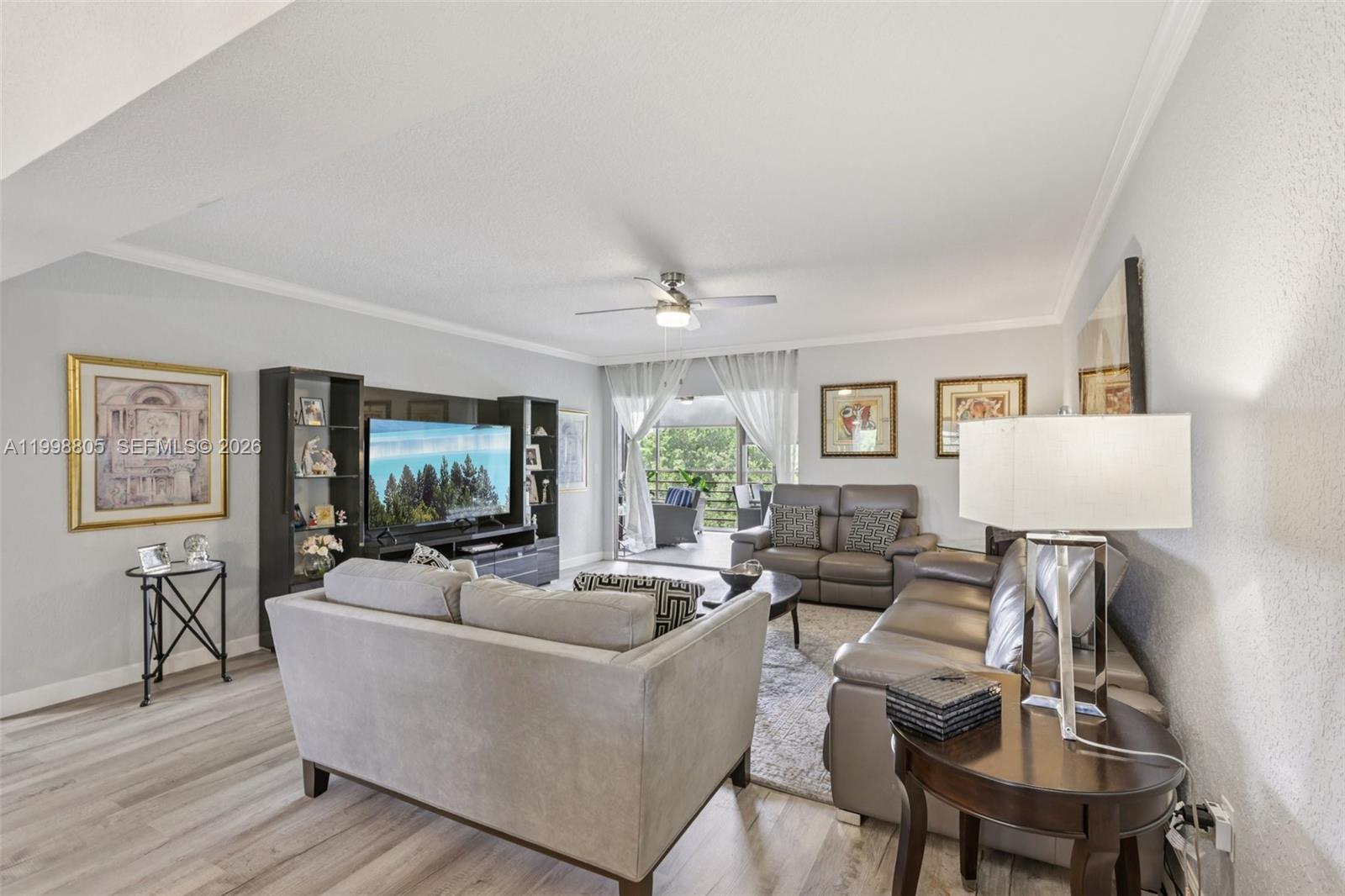 9170 Southwest 14th Street, Unit 4508 Boca Raton, FL 33428 - Photo 4 of 48 a living room with furniture and a flat screen tv