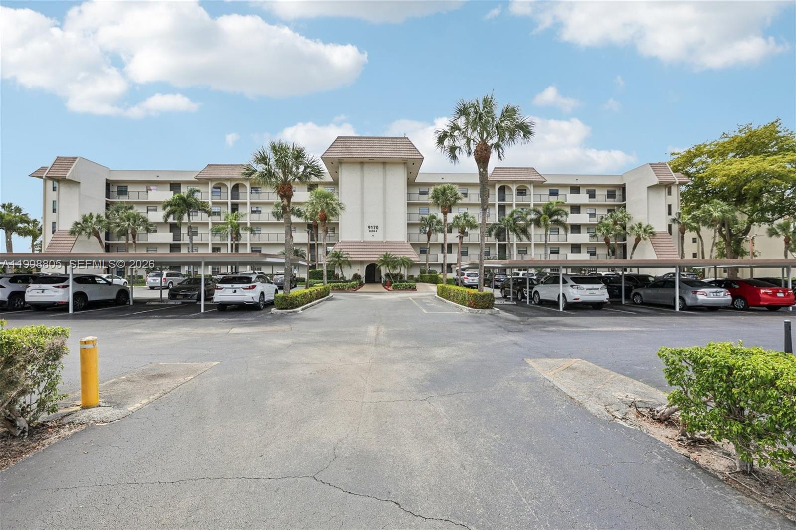 9170 Southwest 14th Street, Unit 4508 Boca Raton, FL 33428 - Photo 6 of 48 a cars parked in front of a building