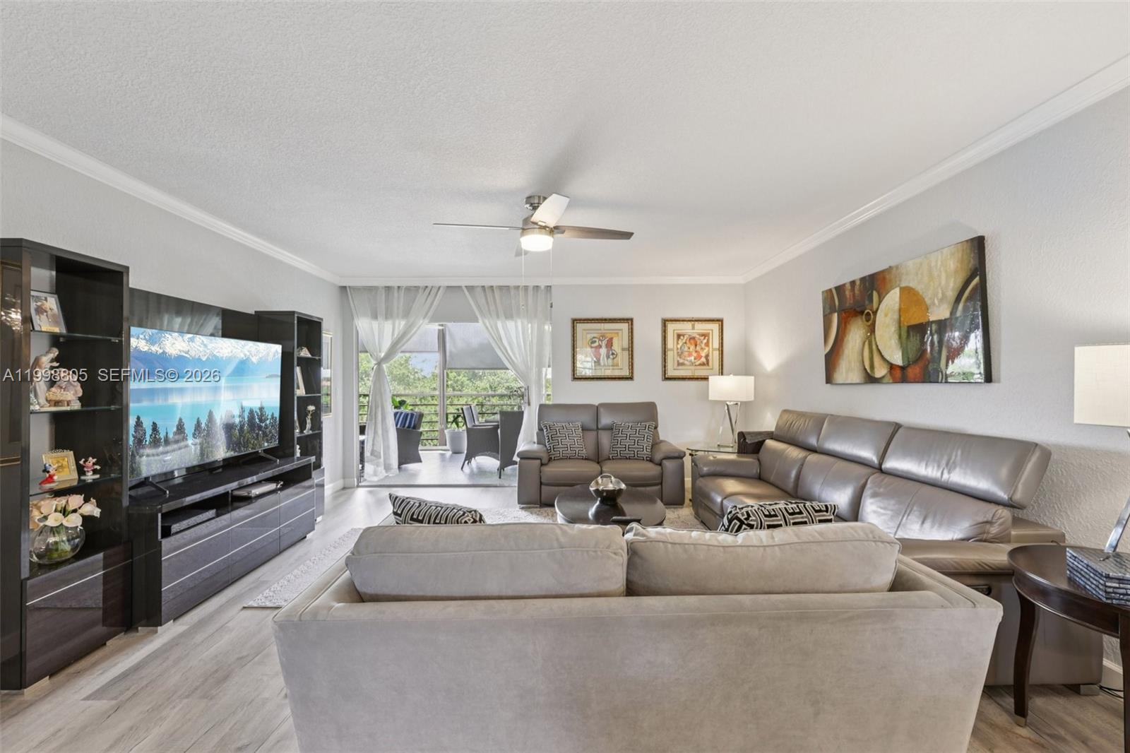 9170 Southwest 14th Street, Unit 4508 Boca Raton, FL 33428 - Photo 8 of 48 a living room with furniture and a flat screen tv