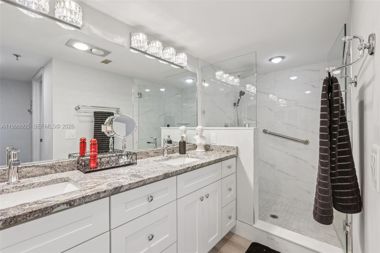 9170 Southwest 14th Street, Unit 4508 Boca Raton, FL 33428 - Photo 9 of 48 a bathroom with a double vanity sink and a mirror