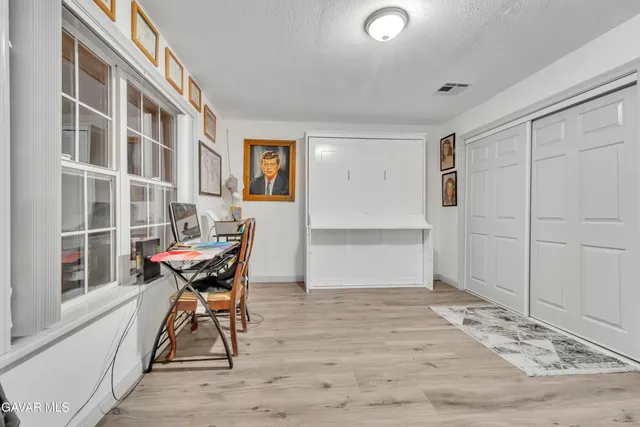 a dining room with a wooden table and chairs