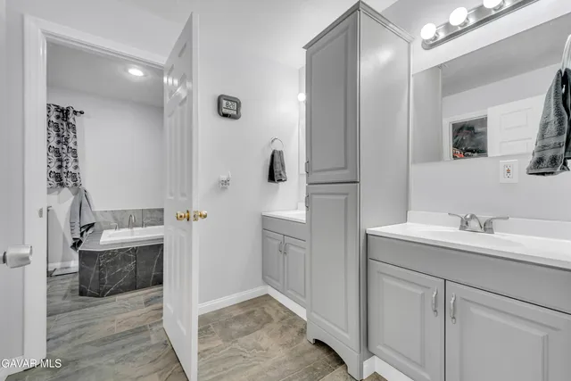 a spacious bathroom with a double vanity sink mirror and