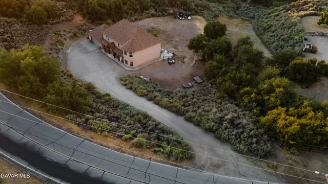 an aerial view of a house with a yard