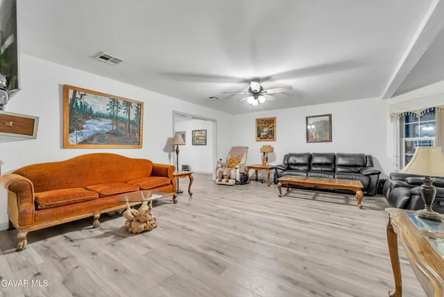 a bedroom with furniture and wooden floor