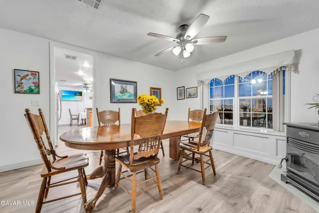 a view of a dining room with furniture and chandelier