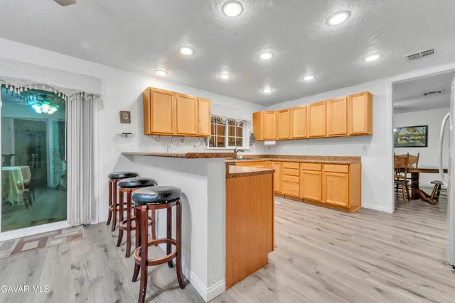 a kitchen with stainless steel appliances granite countertop a refrigerator and a stove top oven