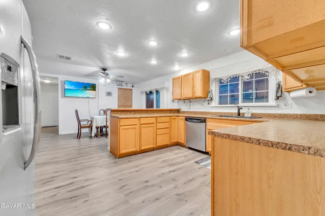 a kitchen with stainless steel appliances granite countertop a sink counter space and cabinets