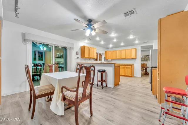 a view of a dining room with furniture and a kitchen