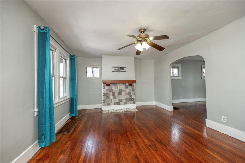 88 Evans Avenue Pittsburgh, PA 15205 - Photo 11 of 41 a view of a big room with wooden floor a chandelier fan and windows