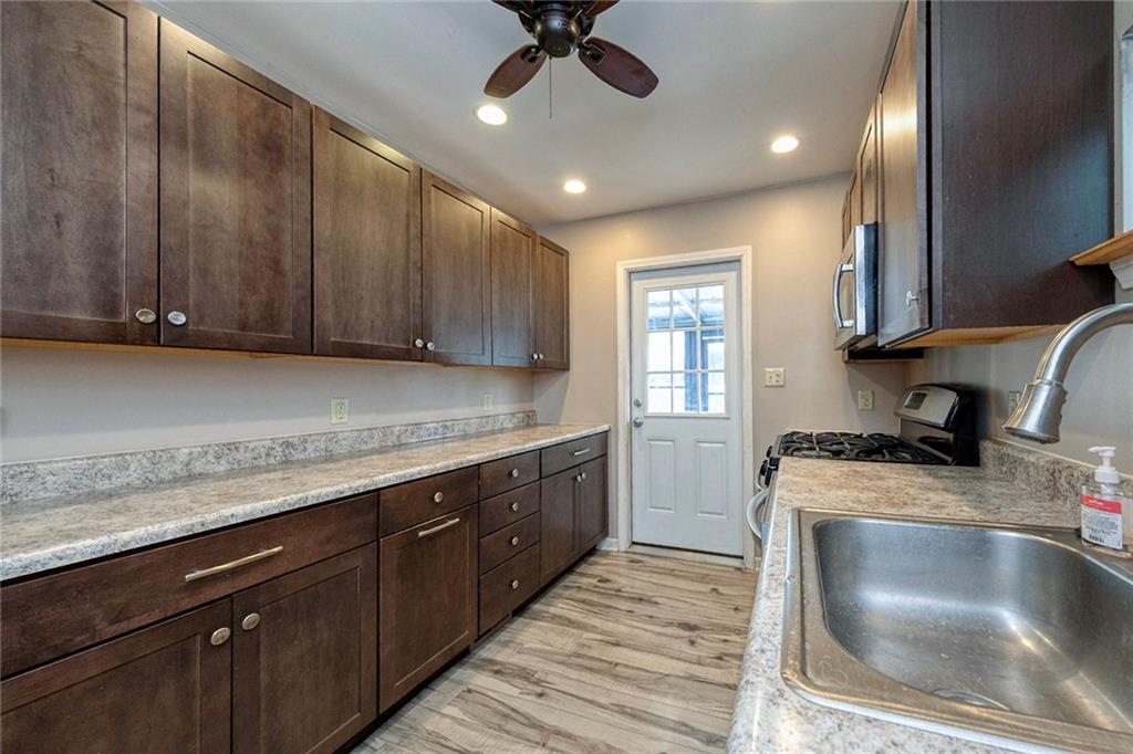 88 Evans Avenue Pittsburgh, PA 15205 - Photo 17 of 41 a kitchen with a stove sink and cabinets