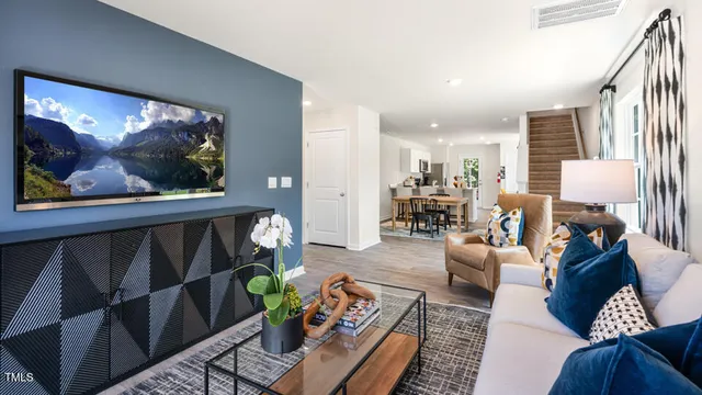 a living room with furniture a dining table and a painting on the wall