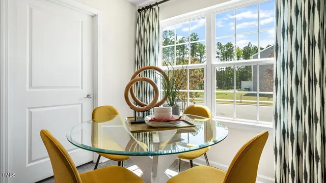 a dining room with furniture and wooden floor
