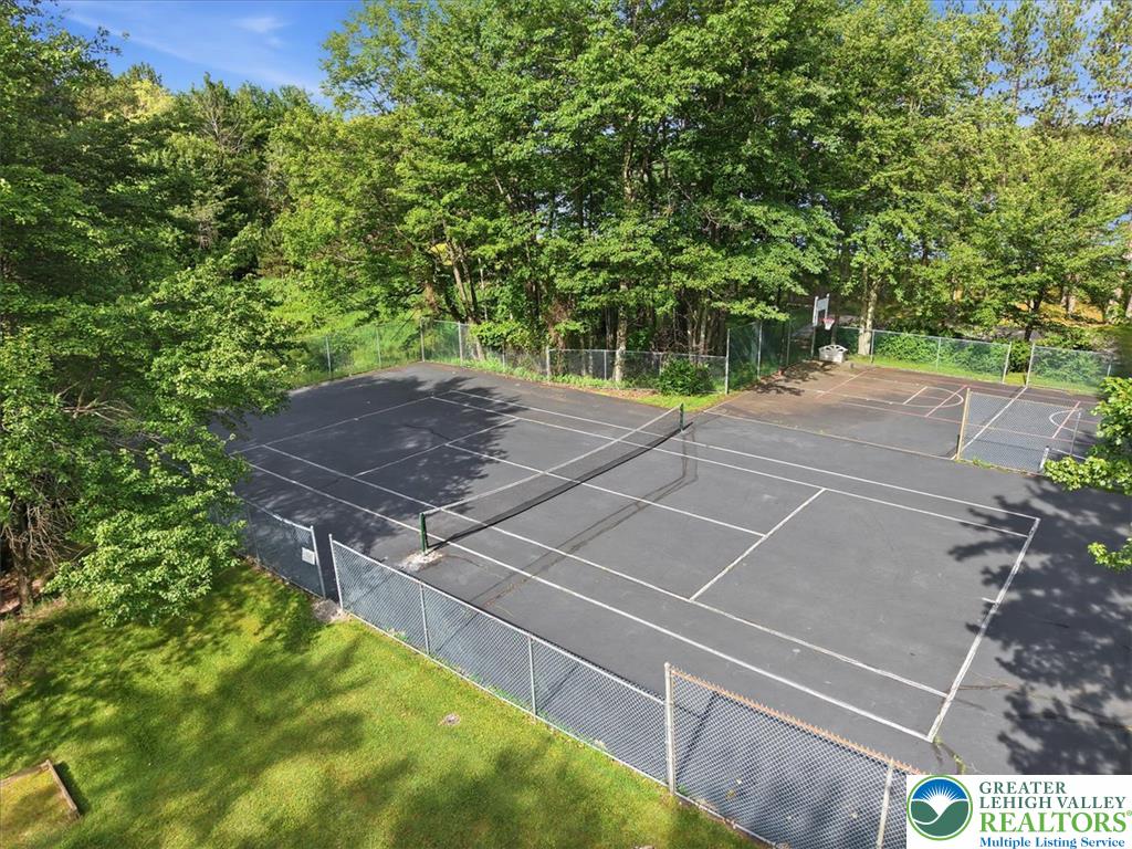 143 Logger Road Canadensis, PA 18325 - Photo 28 of 32 Sporting amenities include a full tennis court and a basketball half-court, both securely fenced.