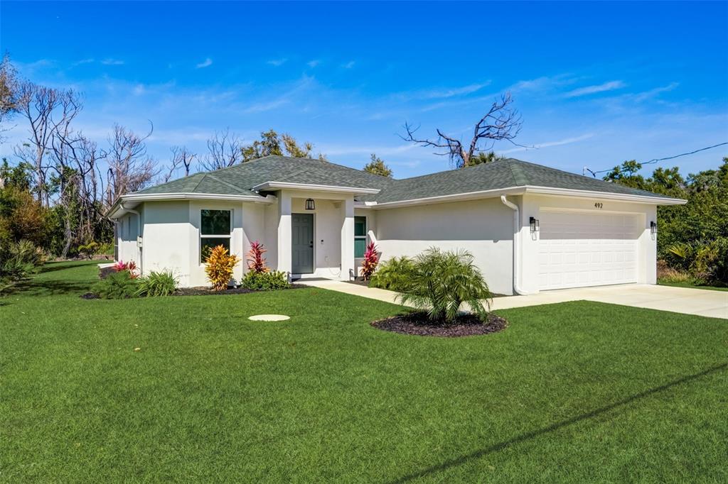492 Sunset Road North Rotonda West, FL 33947 - Photo 1 of 1 a front view of a house with a garden