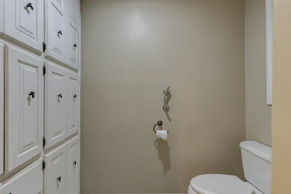a white toilet sitting next to a bathroom sink