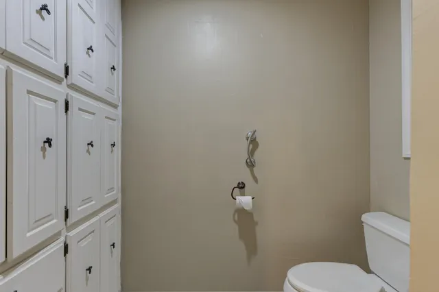 a white toilet sitting next to a bathroom sink