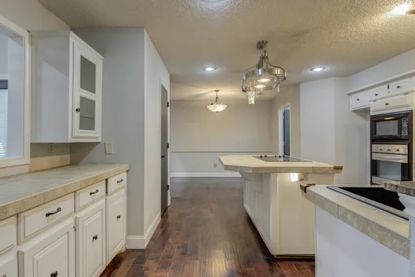 a kitchen with stainless steel appliances a white stove top oven and cabinets