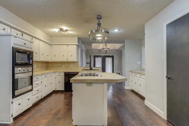 a kitchen with a stove oven and sink