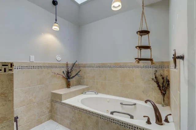a bathroom with a bathtub and shower