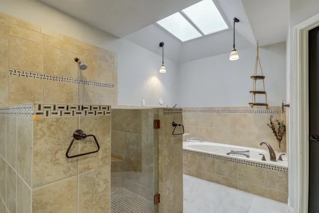 a bathroom with a bathtub and a shower