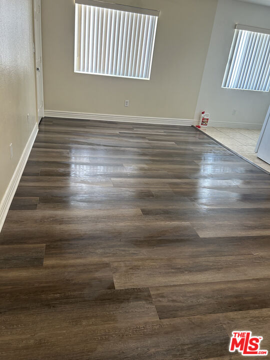 138 West 97th Street Los Angeles, CA 90003 - Photo 6 of 8 a room with hard wood floor and a window