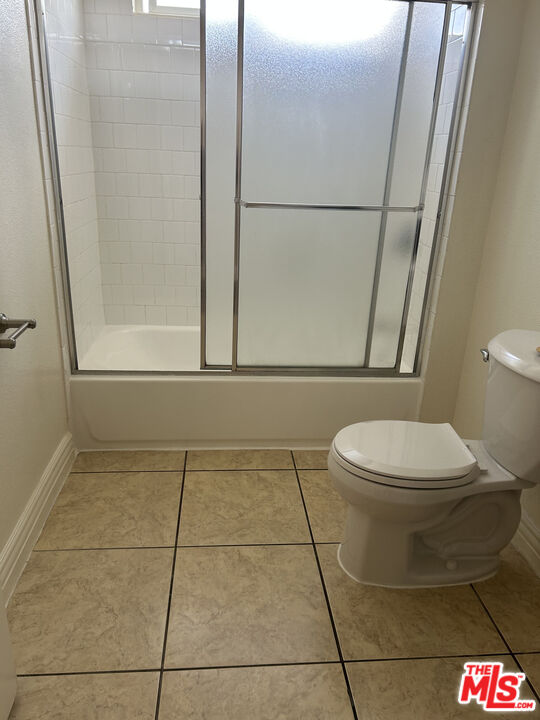 138 West 97th Street Los Angeles, CA 90003 - Photo 7 of 8 a bathroom with a toilet and a shower