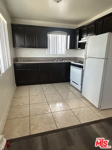 a kitchen with a cabinets and a refrigerator