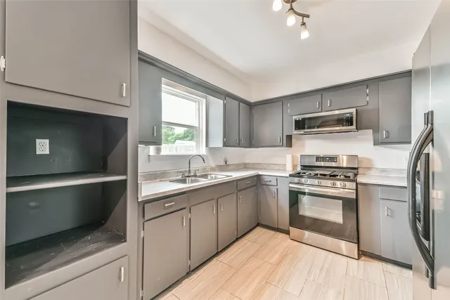 a kitchen with a sink stove and microwave