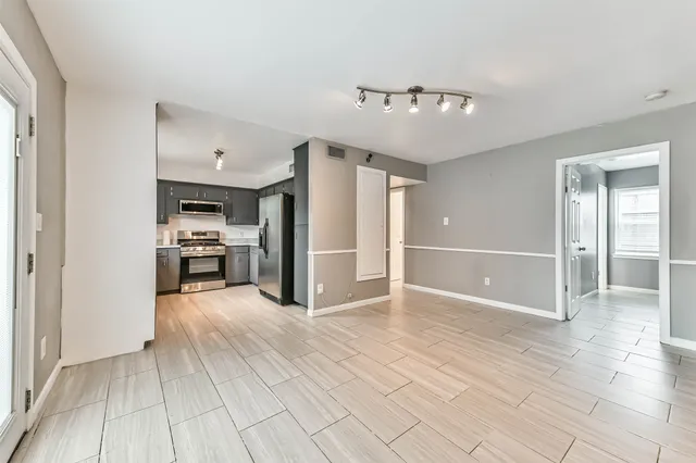 a view of a kitchen with furniture and an empty room