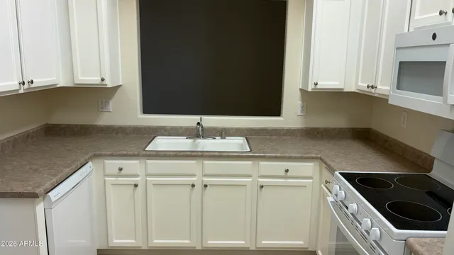 a kitchen with a sink and cabinets