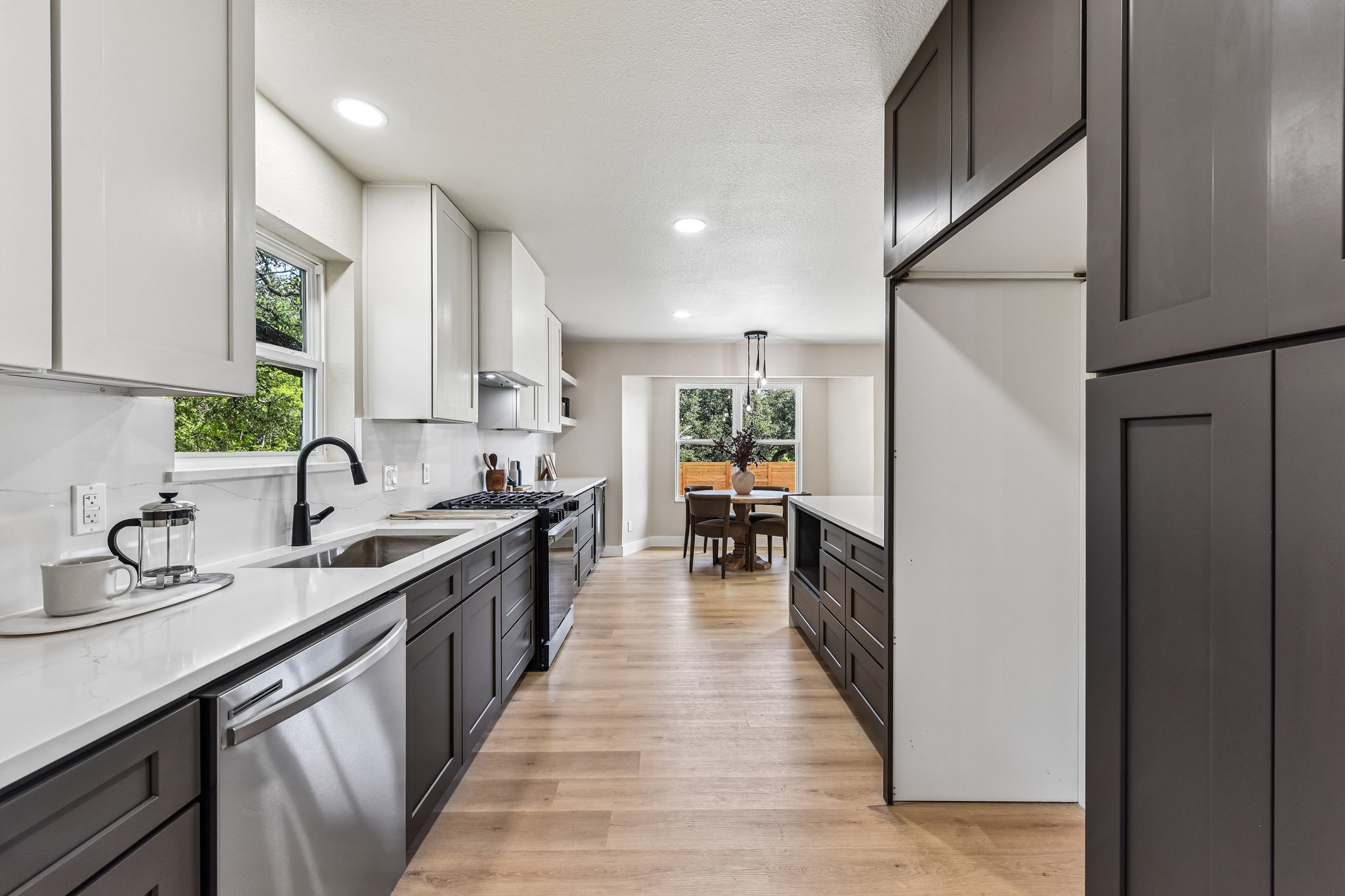 7523 Glenhill Road Austin, TX 78752 - Photo 10 of 38 Culinary aspirations find a home in this sleek kitchen, complete with modern appliances and generous counter space.