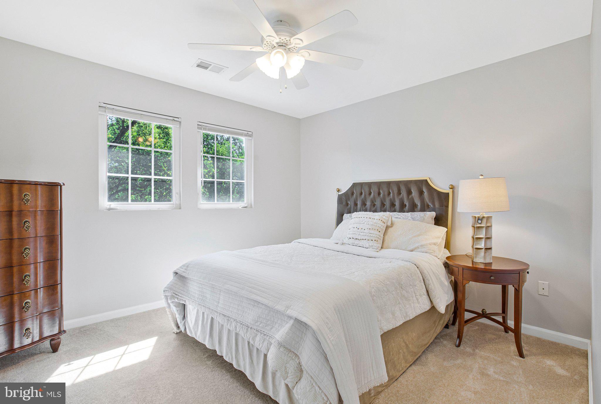 13215 Falls Road Cockeysville, MD 21030 - Photo 16 of 40 a bedroom with a bed and a chandelier