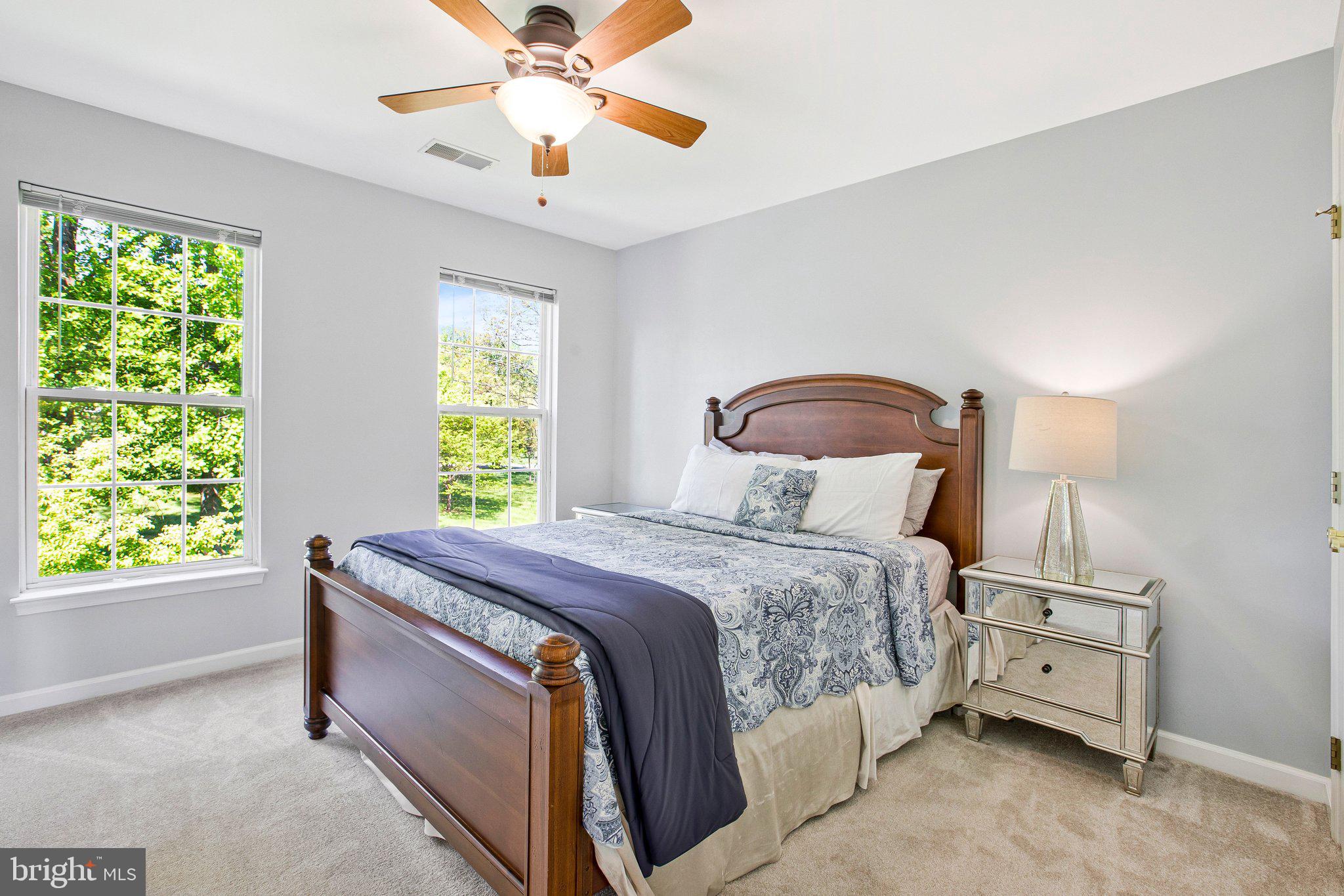 13215 Falls Road Cockeysville, MD 21030 - Photo 17 of 40 a bedroom with a bed and a chandelier