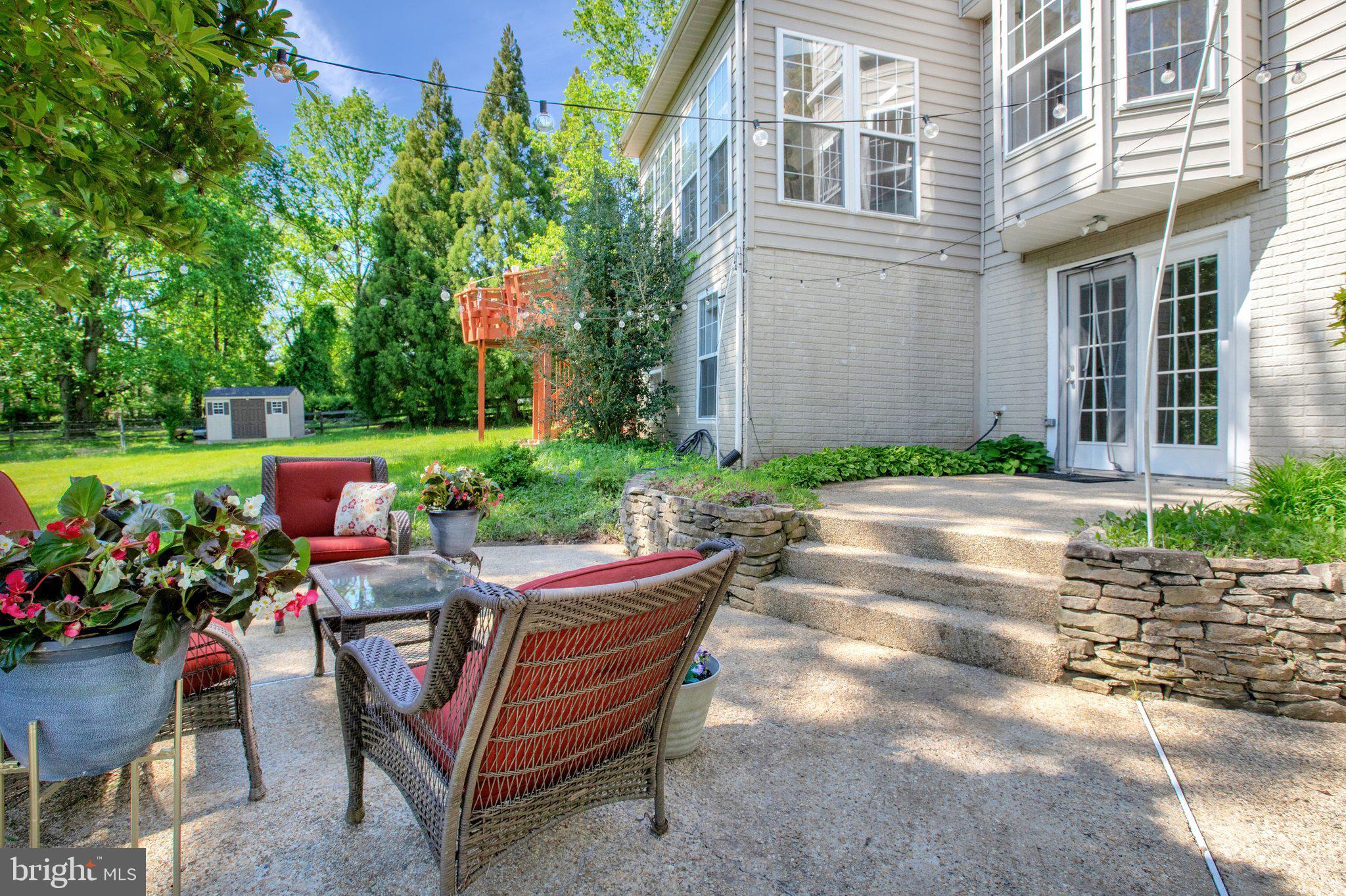 13215 Falls Road Cockeysville, MD 21030 - Photo 28 of 40 a backyard of a house with a yard and outdoor seating