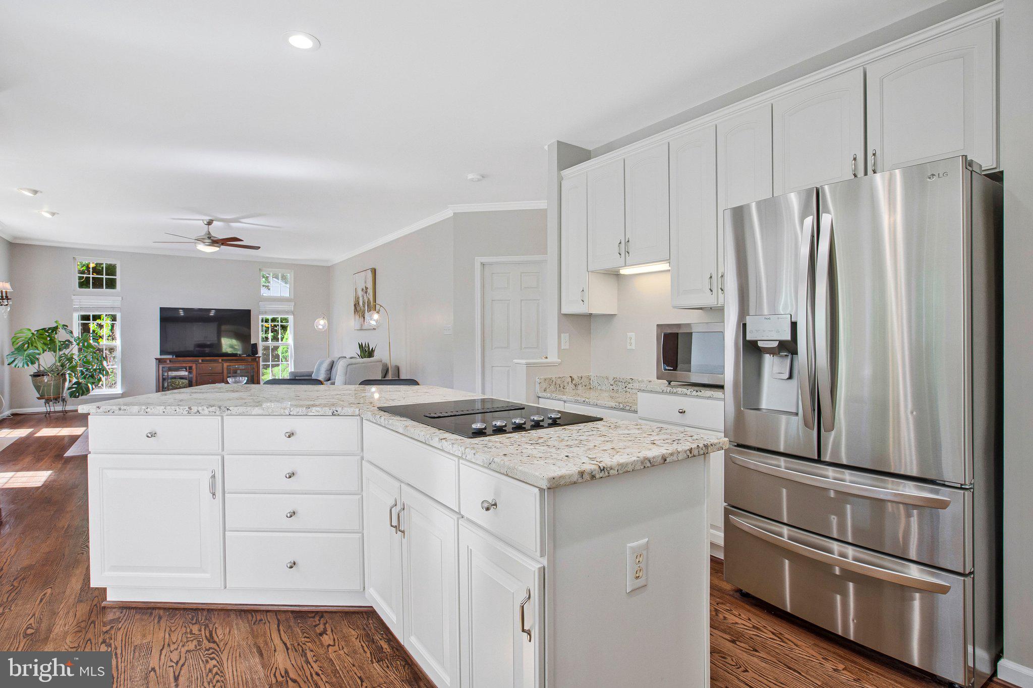 13215 Falls Road Cockeysville, MD 21030 - Photo 4 of 40 a kitchen with white cabinets and stainless steel appliances