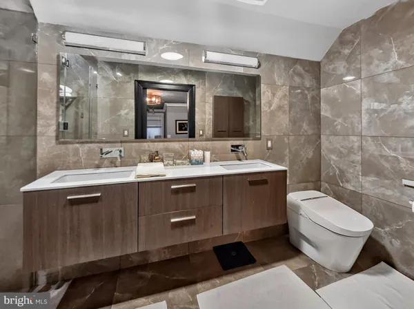 a bathroom with a sink toilet and mirror