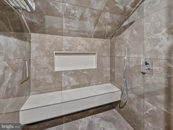 a bathroom with a bathtub and shower