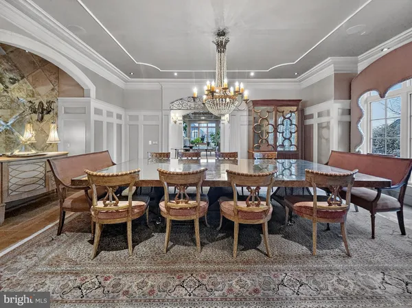 a outdoor dining space with furniture and a chandelier