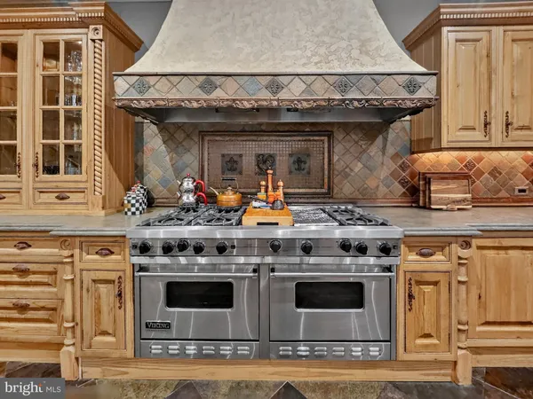 a stove top oven sitting inside of a kitchen