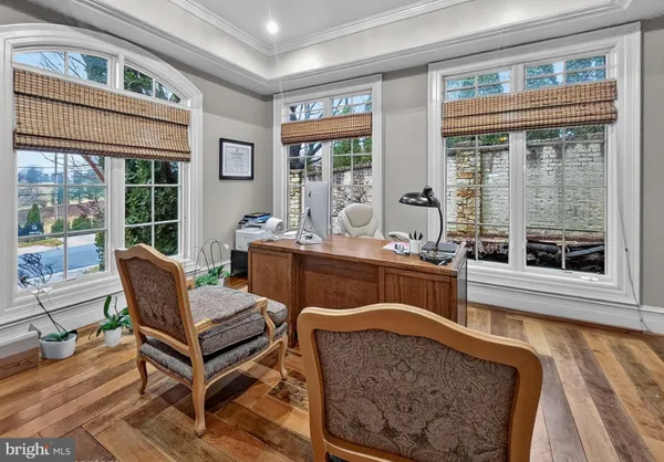 a dining room with furniture a rug and wooden floor