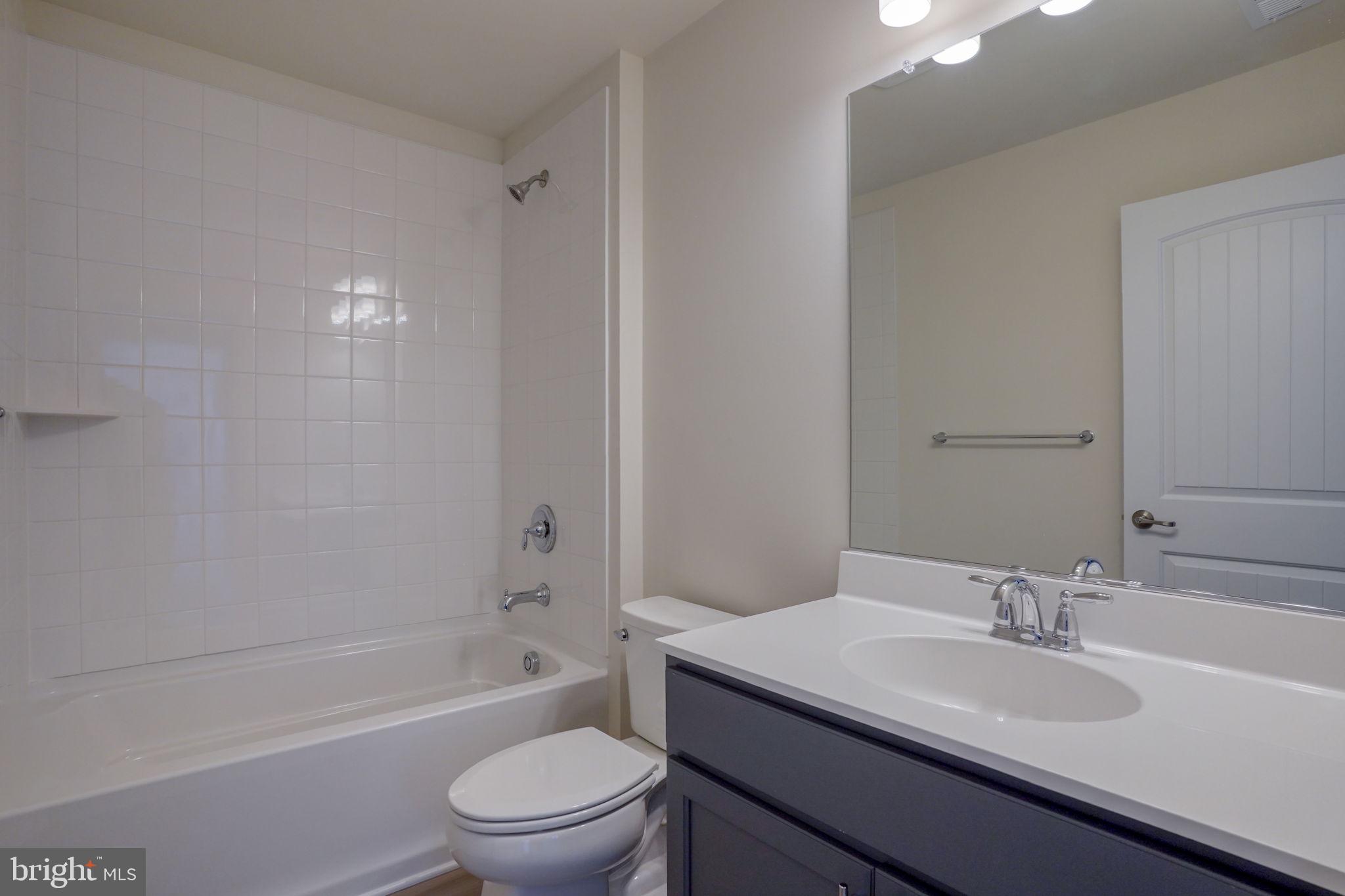 33828 Coldstream Street Frankford, DE 19945 - Photo 34 of 48 a bathroom with a sink a toilet and a bathtub