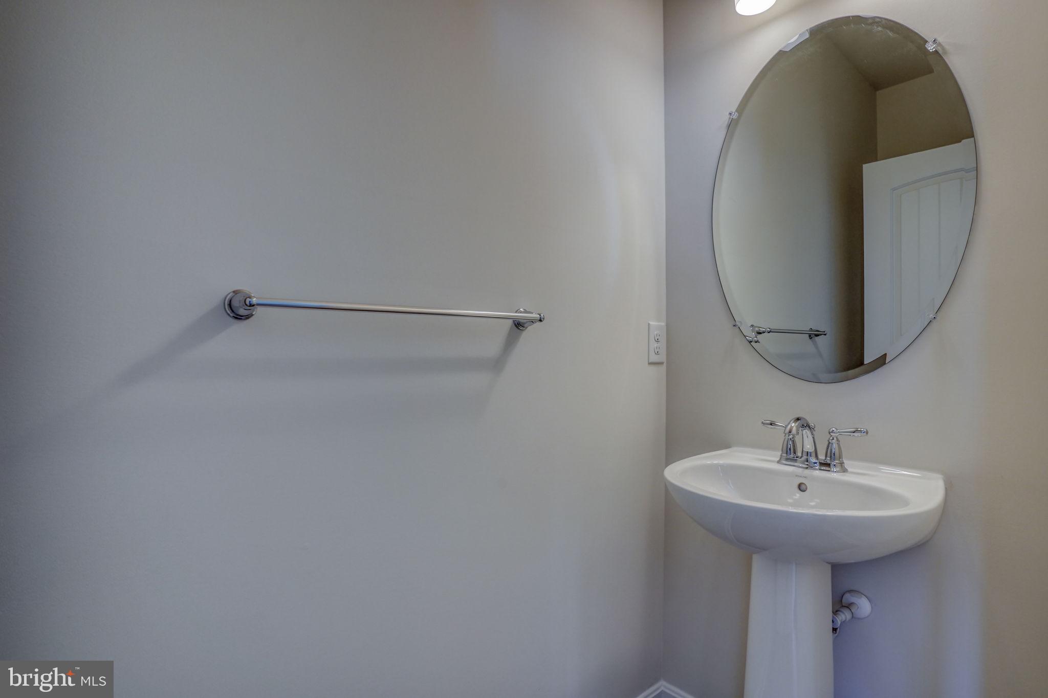 33828 Coldstream Street Frankford, DE 19945 - Photo 10 of 48 a bathroom with a sink and mirror