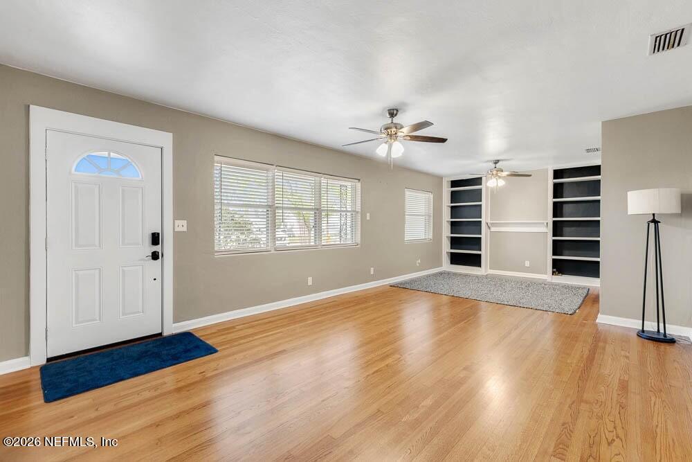 773 Wren Road Jacksonville, FL 32216 - Photo 3 of 17 wooden floor in an empty room with a window