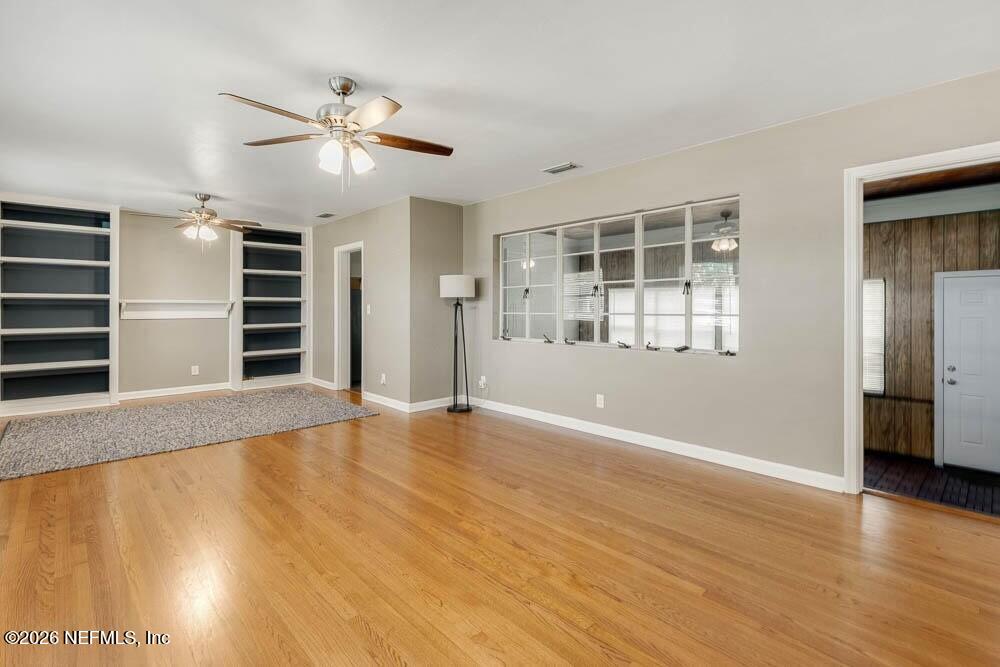 773 Wren Road Jacksonville, FL 32216 - Photo 4 of 17 a view of an empty room with a window and wooden floor