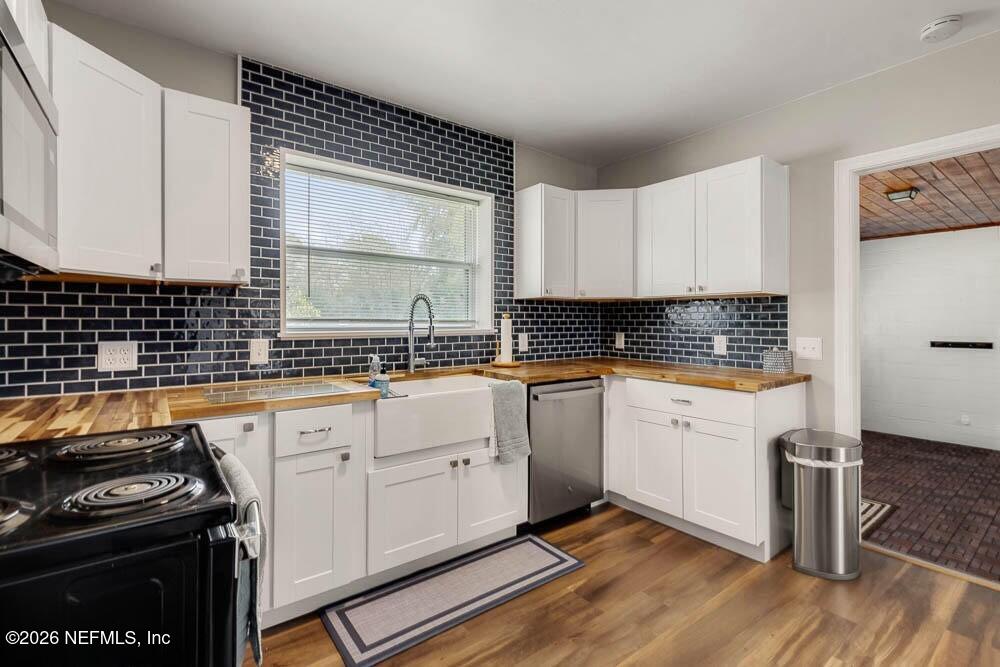 773 Wren Road Jacksonville, FL 32216 - Photo 8 of 17 a kitchen with granite countertop a stove sink and cabinets