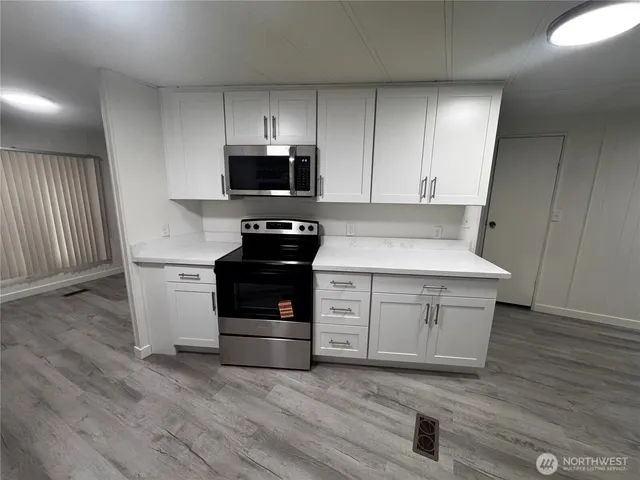 a kitchen with a stove and a microwave