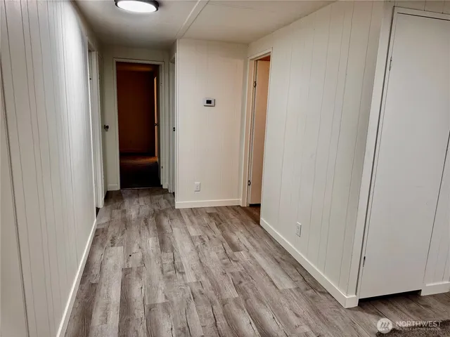 a view of a room with wooden floor